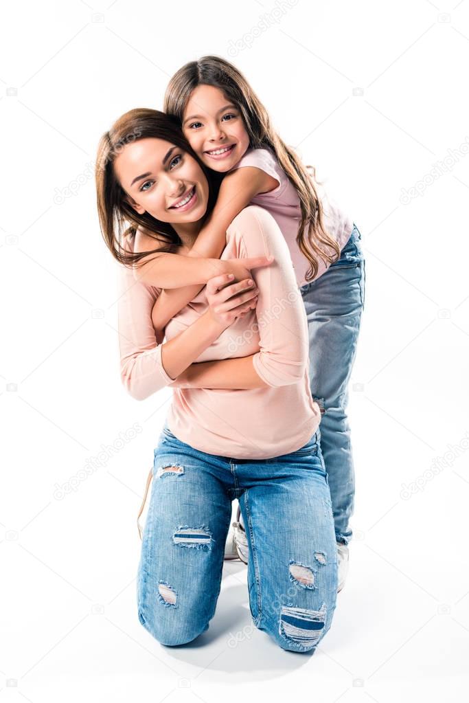Daughter hugging smiling mother