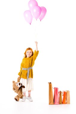 red hair child holding bundle of balloons and teddy bear in hands isolated on white clipart