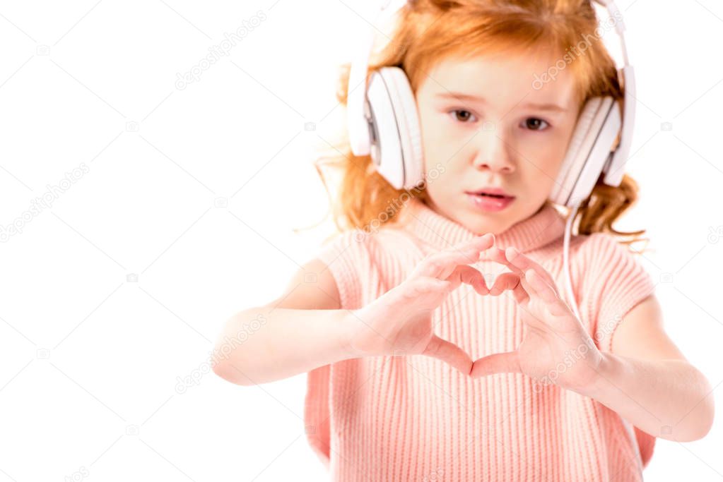 red hair kid in headphones showing heart with fingers isolated on white