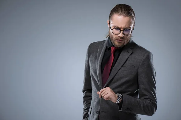Businessman Glasses Looking His Watch Isolated Gray — Stock Photo, Image