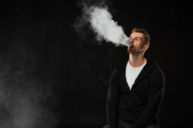 Genç adam vaping elektronik sigara buhar bulutlar tarafından çevrili sakallı