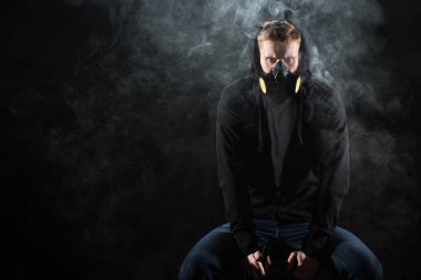 Man wearing protective filter mask smoking electronic cigarette clipart