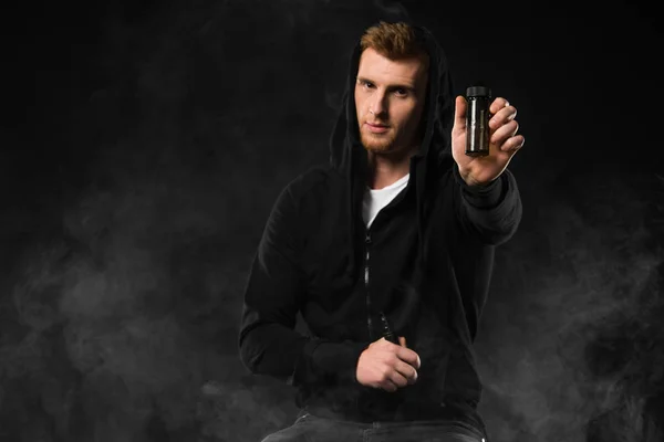 Young Bearded Man Showing Liquid Bottle Surrounded Clouds Steam — Stock Photo, Image