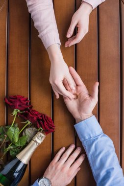 cropped image of boyfriend proposing girlfriend and giving wedding ring clipart