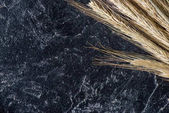close up view of wheat on dark marble tabletop