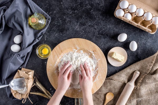 cropped shot of woman kneading dough for homemade bread 