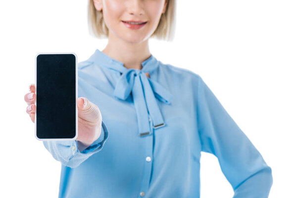 cropped view of businesswoman showing smartphone with blank screen, isolated on white