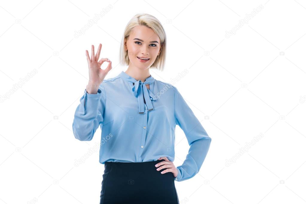 portrait of smiling woman showing ok sign isolated on white