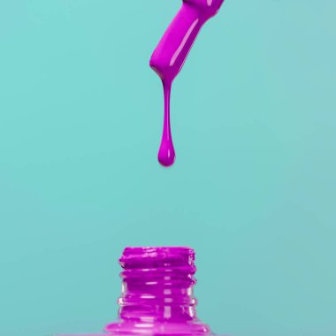 nail polish pouring down into bottle isolated on blue clipart
