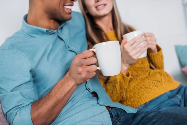 Cropped Image Smiling Multicultural Couple Sitting Sofa Coffee — Stock Photo, Image