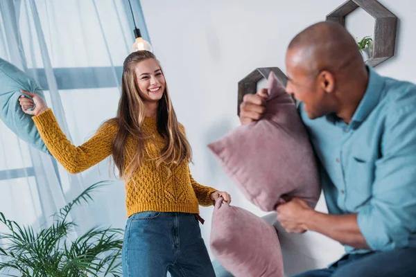 Multicultural Couple Having Fun Fighting Pillows — Free Stock Photo