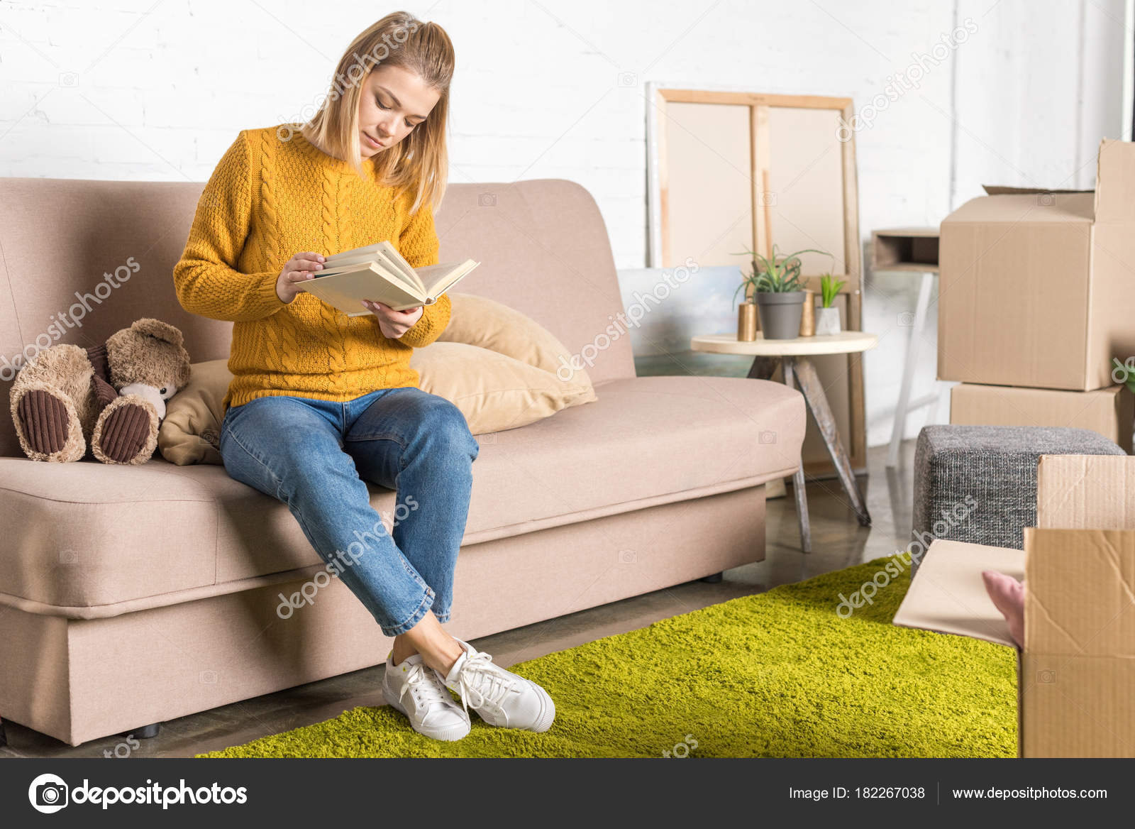 Attractive Young Woman Sitting Sofa Reading Book Relocation Stock Photo ...