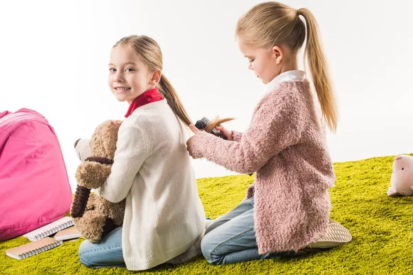 Adorable Child Brushing Hair Sister While Sitting Floor Isolated White — Free Stock Photo