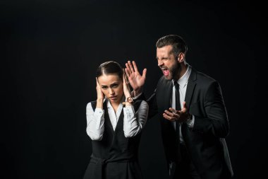 angry boss yelling at businesswoman, isolated on black clipart