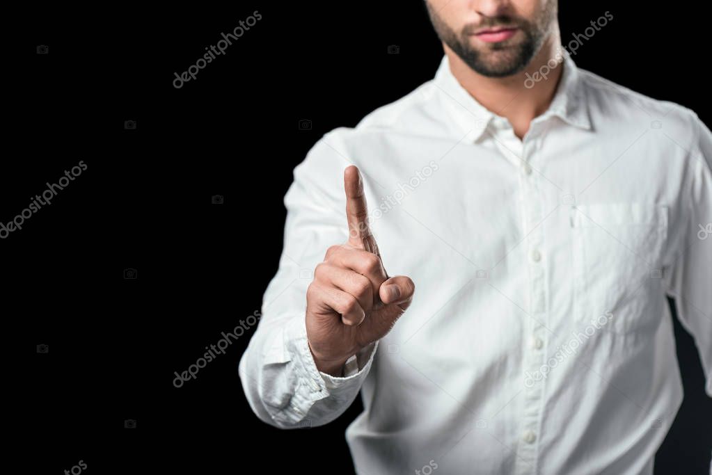 cropped view of businessman pointing up, isolated on black