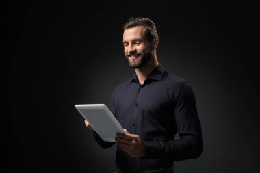 portrait of smiling man with digital tablet isolated on black clipart