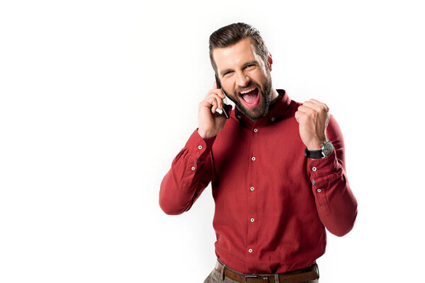 portrait of excited man talking on smartphone isolated on white