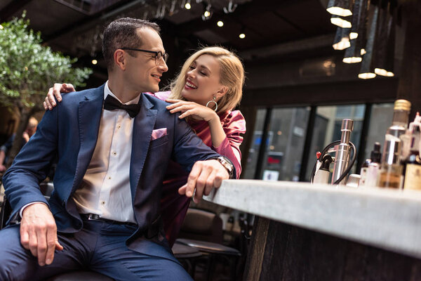 adult woman flirting with handsome man at bar counter