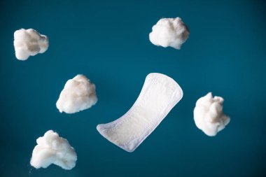 falling daily pad and pieces of cotton isolated on blue clipart