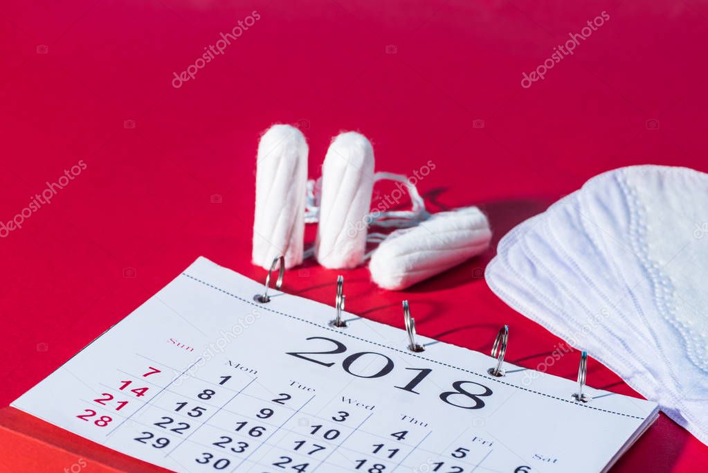 tampons, daily liners and calendar on red
