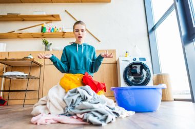 shocked young woman looking at laundry clipart
