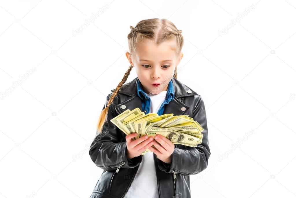 Shocked kid looking at banknotes in hands isolated on white