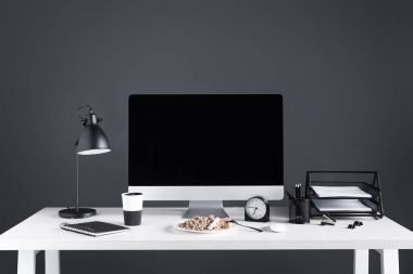 desktop computer with blank screen, food on plate and office supplies at workplace clipart