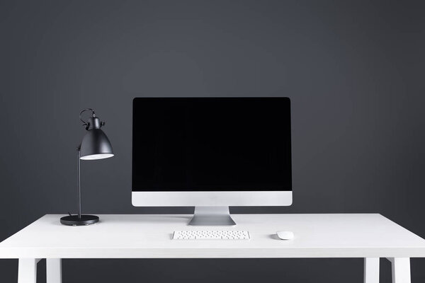 desktop computer with blank screen with keyboard and computer mouse on table 