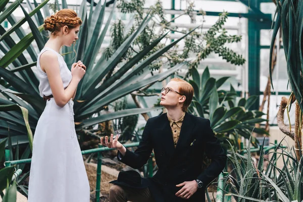 Young Man Standing Knee Making Proposal Beautiful Redhead Girl Botanical — Stock Photo, Image