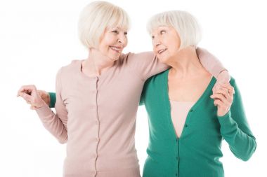 İki üst düzey şık kadın izole üzerinde beyaz kucaklayan