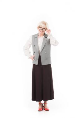 Stylish senior businesswoman looking over eyeglasses isolated on white clipart