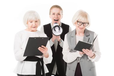 Mature businesswoman with megaphone between two senior businesswomen with clipboard and textbook isolated on white clipart