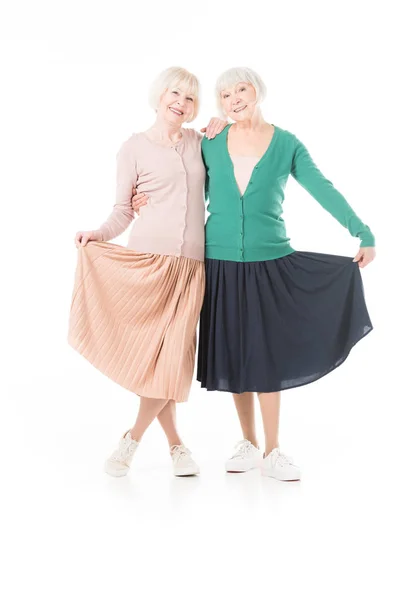 Portrait Smiling Stylish Senior Women Holding Skirts Isolated White — Free Stock Photo