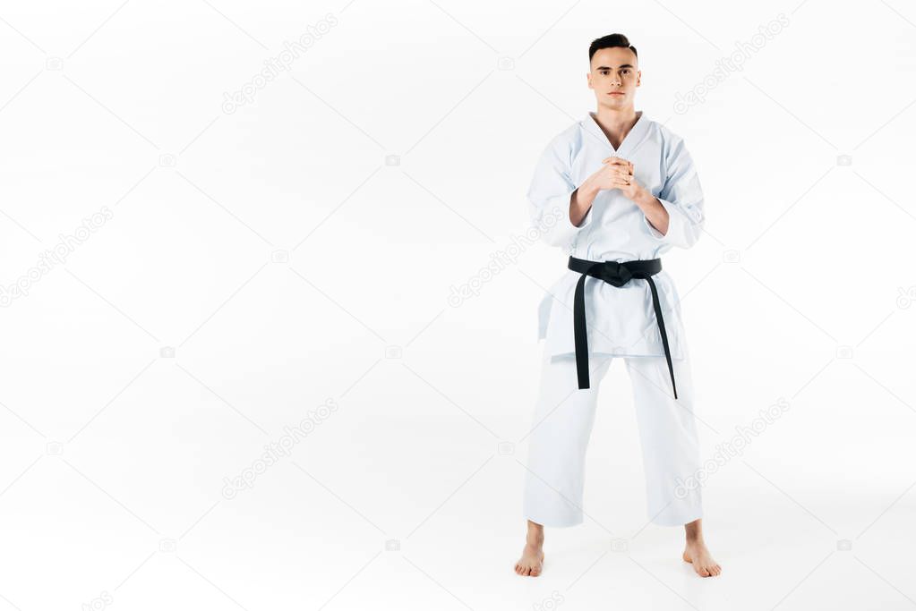 male karate fighter stretching fingers isolated on white