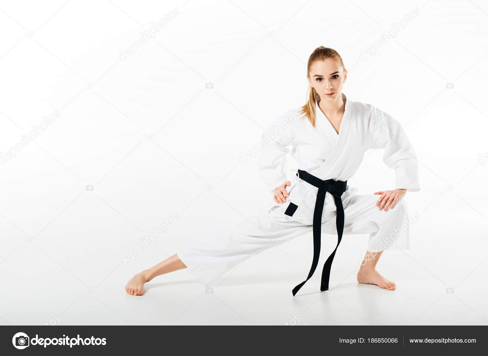 Female Karate Fighter Stretching Looking Camera Isolated White — Stock