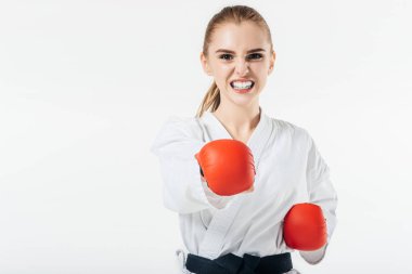 female karate fighter exercising with gloves and mouthguard isolated on white clipart