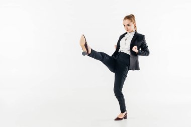 businesswoman performing karate kick in suit and high heels isolated on white clipart
