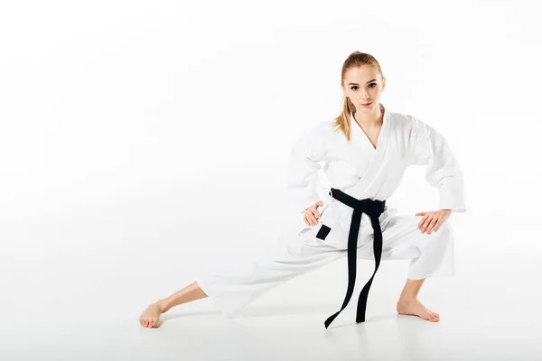 Female Karate Fighter Stretching Looking Camera Isolated White — Stock Photo, Image
