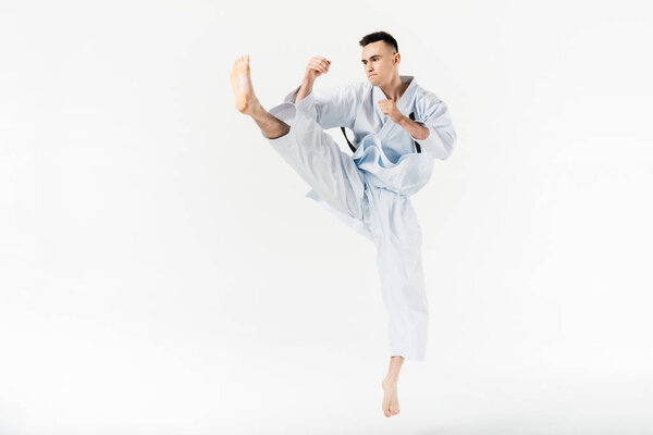 Карате-бойцы выполняют удар, изолированный на белом
