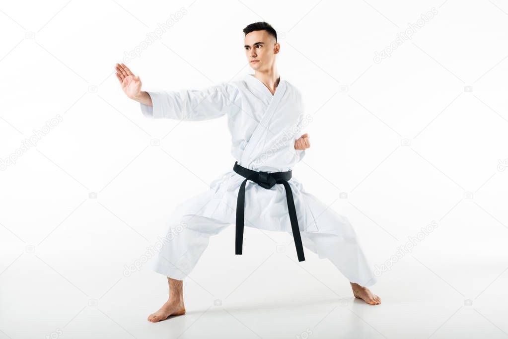 male karate fighter standing in pose isolated on white