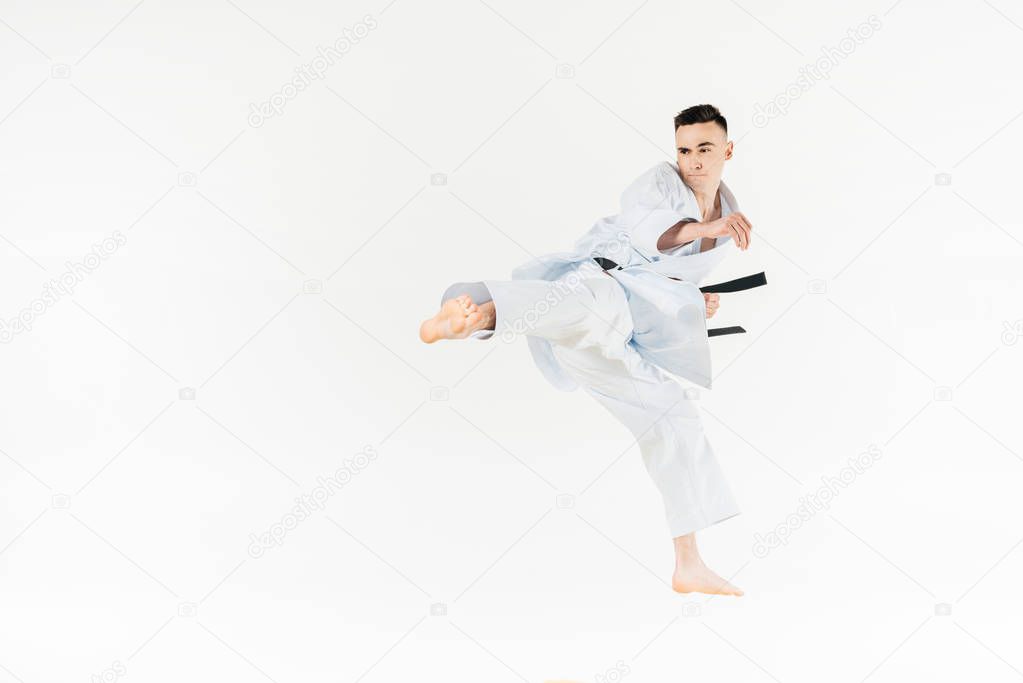 male karate fighter training isolated on white
