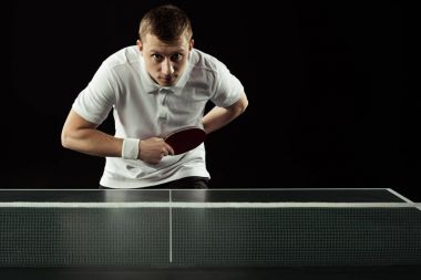 young tennis player playing table tennis isolated on black clipart