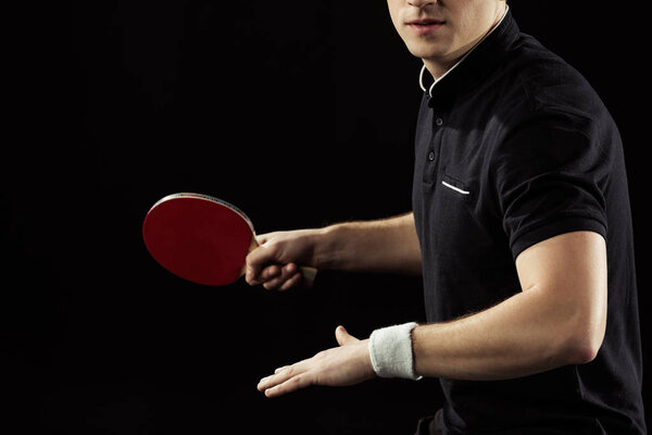 partial view of tennis player with tennis racket in hand