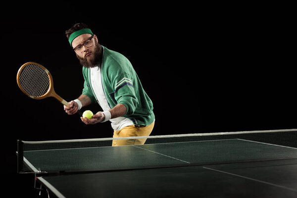 sportsman playing table tennis alone isolated on black