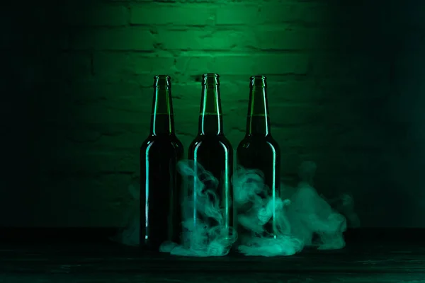 Three Green Beer Bottles Smoke Green Light — Stock Photo, Image