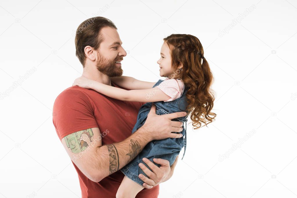 Side view of father holding little daugther in hands isolated on white
