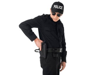 Policeman in uniform pulling out gun isolated on white clipart