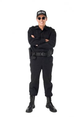 Smiling policeman with arms folded isolated on white clipart