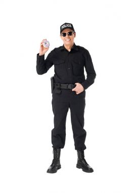 Smiling policeman in uniform holding doughnut isolated on white clipart