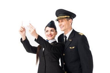 Airline captain and stewardess taking selfie isolated on white clipart